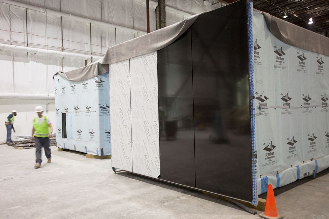 These modules are almost ready for shipping to the job site at Atlantic Yards; you can see the shiny black exterior panels which will form part of the wall of the skyscraper.